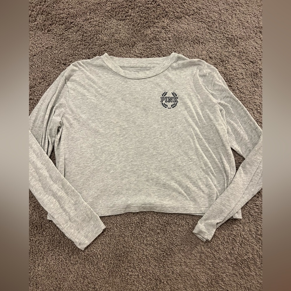 This is a Victoria’s secret Pink CROPPED long sleeve shirt in a size medium.